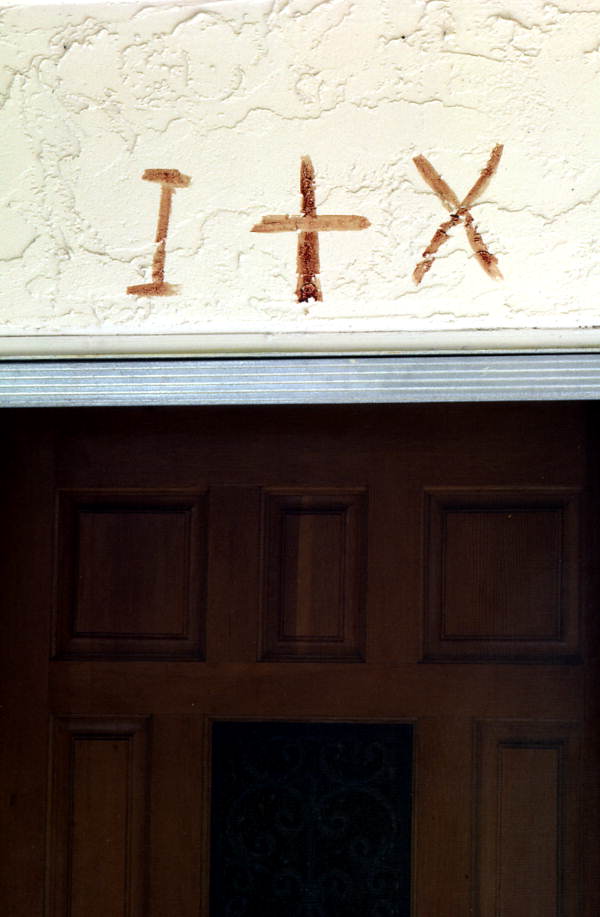 Symbols in sheep's blood over Nikitas Tsimouris' door - Tarpon Springs, Florida.