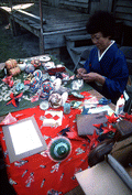 Kazuko Law making origami at the Great Gulf Coast Arts Festival- Pensacola, Florida.