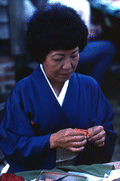 Kazuko Law making origami at the Great Gulf Coast Arts Festival- Pensacola, Florida.