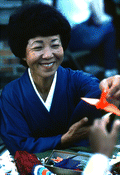 Kazuko Law handing out origami at the Great Gulf Coast Arts Festival- Pensacola, Florida.