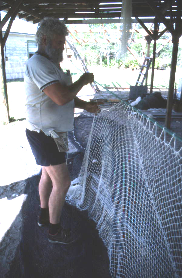 Costa Buzier hanging a trawl net and sewing webbing - Apalachicola, Florida.