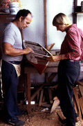 Bobby Shiver shows Nancy Nusz a boat model made by his son - Eastpoint, Florida