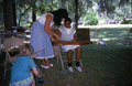 Eugenia Fitchen teaching a girl old-time dulcimer music at the Children's Activity Area- White Springs, Florida