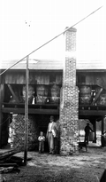 C.B. Harrison and son in front of government plan still supervised by C. H. Coulter