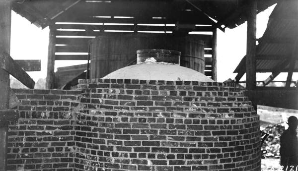 Mortar covering asbestos board on top of kettle of J.T. Miller's government plan still