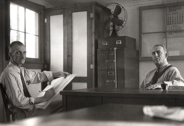 Artist sketching the police chief at the FERA camp : Ocala, Florida (ca.1936)