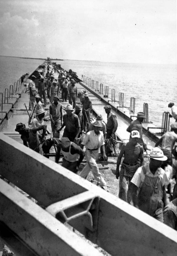 Converting the tracks of the Florida East Coast Railway into a new bridge for automobiles in the Florida Keys (circa 1937).