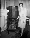 A chair in the Governor's Mansion being shown by Mary Harwood Caldwell