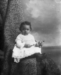 African American infant holding a rattle.