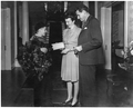 Boy selling Christmas seals for the American Lung Association to Governor Millard F. Caldwell and his wife.