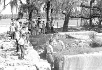 Archaeologists showing children excavated ruins of Fort San Marcos de Apalache (1965)