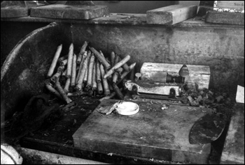 Cigars and materials used in creating them on a work station desk top inside "Rex of Key West" cigar factory (between 1970 and 1985)