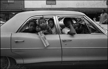 Unidentified children holding a "Free Bill Johnson political prisoner" bumper sticker at rally in Frenchtown: Tallahassee, Florida (July 31, 1971)