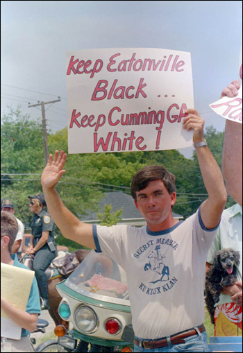 Klansman John Baumgardner holds a sign at the Parade: Eatonville, Florida (August 15, 1987)