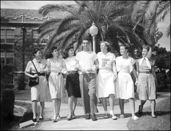 Female students gather around a male student at Florida State College for Women: Tallahassee, Florida (1946)