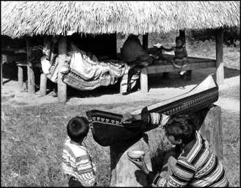 Florida Seminole Harry Jumper paints a canoe to be awarded to the winner of the FSU – Miami football game: Hollywood Seminole Indian Reservation, Dania, Florida (1955)