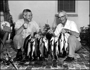 Governor LeRoy Collins helps his father, Marvin Sr., hold up their catch of black bass (1958)