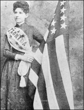 Mena E. Williams Hirshberg stands by a U.S. flag: Tallahassee, Florida (1885)