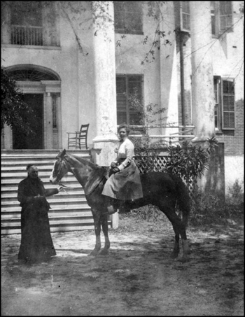 Ellen Call Long welcomes a guest on horseback to "The Grove" (ca. 1900)