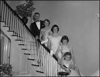 The Collinses pose for a family portrait on the staircase (1956)