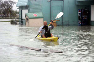 Man kayaking with dog on Flagler Avenue by the Salvation Army store: Key West, Florida (2005)