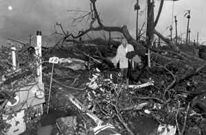Harold Wilkins walks through rubble left by Hurricane Andrew: Florida City, Florida (1992)
