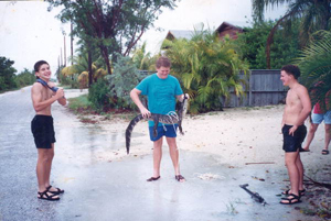 Schlesna brothers and friend with alligator they caught: Ramrod Key, Florida (1992)