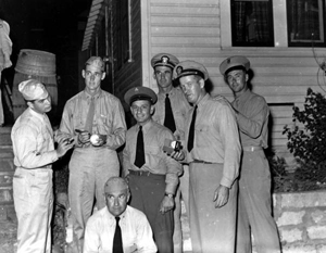 Ted Williams signing a baseball for Navy personnel: Panama City, Florida (ca. 1943)