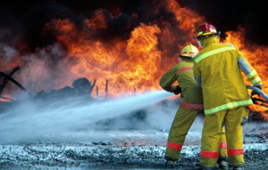 Members of the Key West Fire Dept. practice with NASKW firefighters at the "Hot drill" pit (1987)