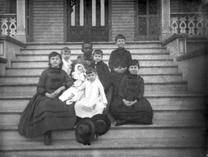 Children and their baby sitter on the steps of the Leon Hotel