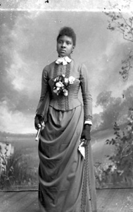 Woman holding a parasol and handkerchief