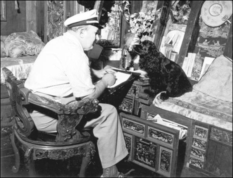 Mr. Ripley and his dog in the cabin of his junk, the "Mon Lei" (1947)