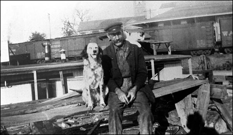 Captain Will Newman sitting on the dock with dog and cat: Palatka, Florida (192-)