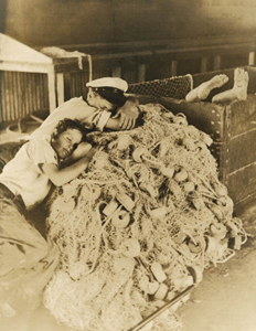 27. Boys sleep in the fish house on the idle nets