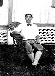 Hideo Kobayashi posing in chair: Yamato, Florida (1914)