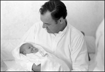 Governor Claude Kirk holding his newborn daughter Claudia: Palm Beach, Florida (August 21, 1968)