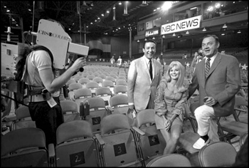 Governor Kirk being filmed with CBS news anchor Mike Wallace and an unidentified woman in convention hall: Miami Beach, Florida (August 2, 1968)