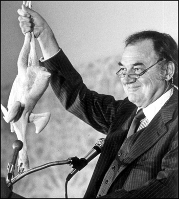 Former Governor Claude Kirk holds up a chicken to emphasize a point: Tallahassee, Florida (1977)