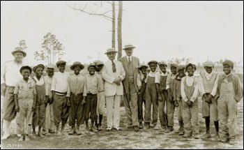 Golf Pro Alec Smith (left) and others posing with caddies: Miami, Florida (1920s)