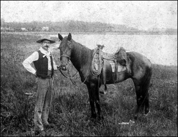 Tom Johnson holding the reins of his horse: Orlando, Florida (189-)