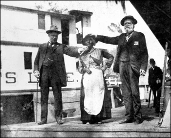 Aunt Scilla standing beside the "Astatula" at the Silver Springs dock: Silver Springs, Florida (189-)