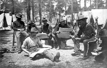 Company E of the 9th Infantry reading newspapers during the Spanish-American war (1898)
