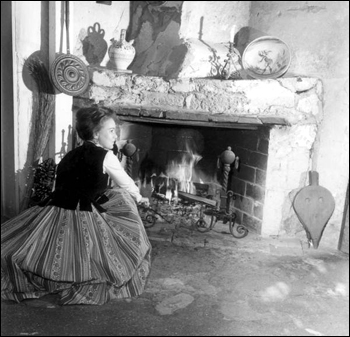 Woman beside the fireplace at the oldest house: Saint Augustine, Florida (1964)