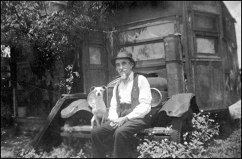 Retired railroad man sitting on the bumper of his house-car (1931)
