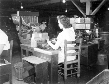 A woman rolling cigars in a cigar plant: Quincy, Florida(1946)