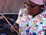 Lucreaty Clark preparing strips of white oak for basket making