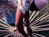 Lucreaty Clark hand weaving strips of white oak to make basket