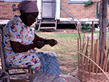 Lucreaty Clark preparing a strip of white oak during basket making