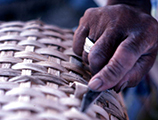 Close-up view of Lucreaty Clark making a white oak basket