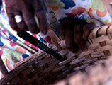 Close-up of Lucreaty Clark finishing her white oak basket